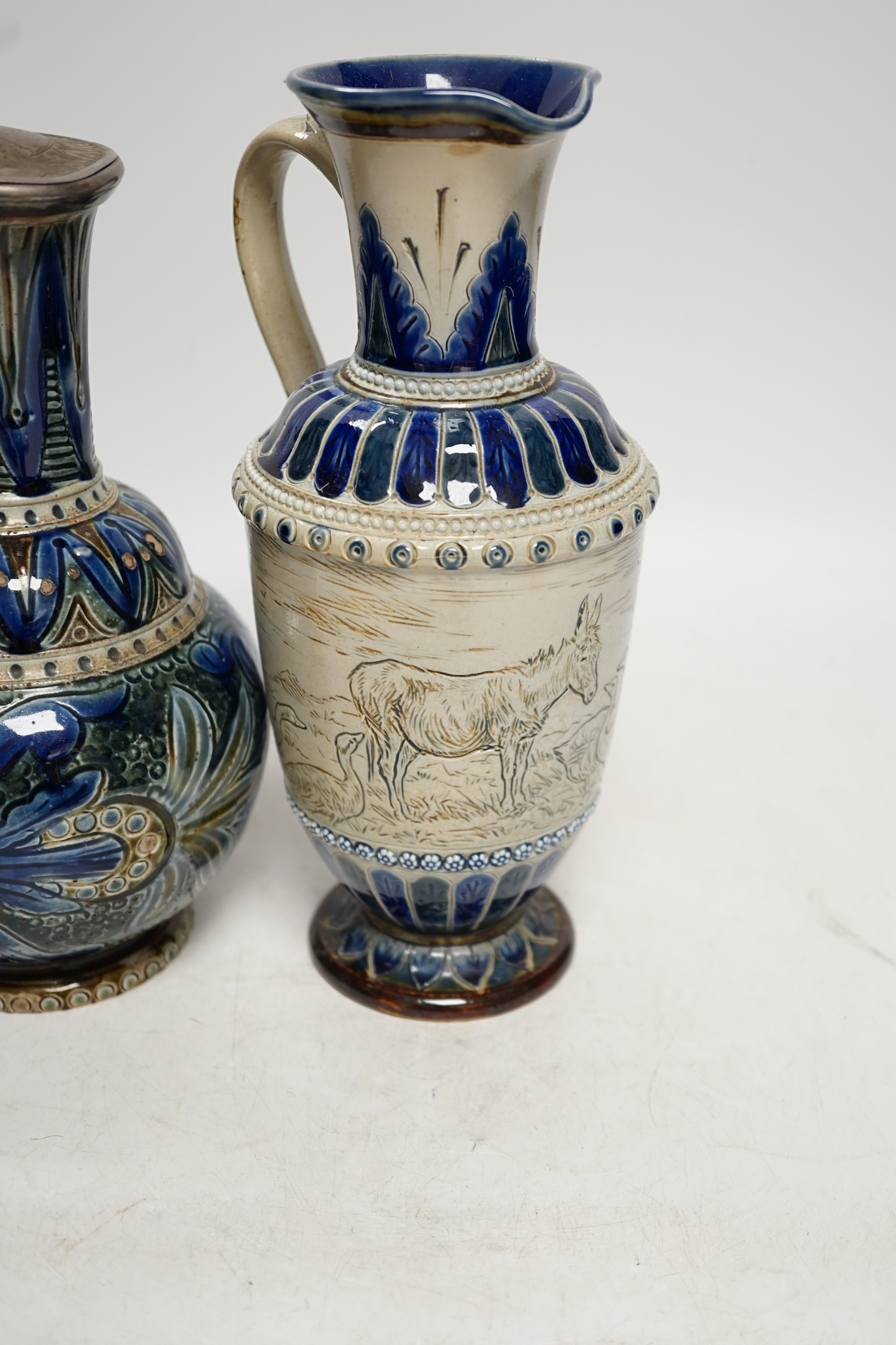 A Hannah Barlow for Doulton ‘geese and donkey’ jug, another jug dated 1874 and a small Royal Doulton vase, largest 24cm high. Condition - good